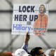 An attendee holds a “LOCK HER UP” sign before the arrival of Trump at a campaign rally, Friday, Nov. 4, 2016, in Wilmington, Ohio. Photo via AP